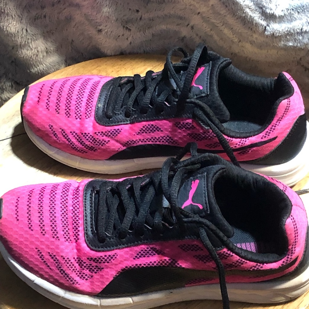 Pink and black running shoe